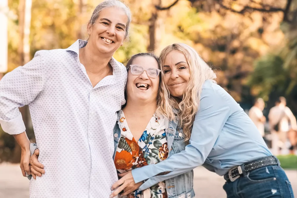 A disabled woman hugging her family